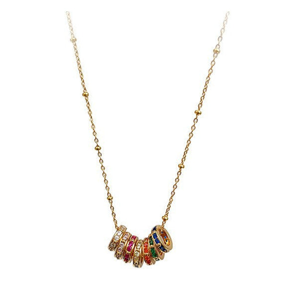 Gold necklace with colorful stones on a white background