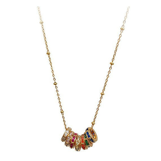 Gold necklace with colorful stones on a white background