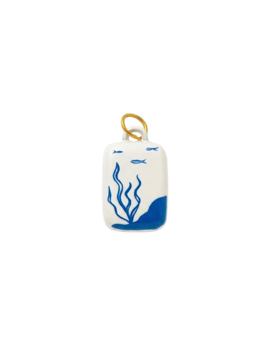 Small rectangular ceramic ornament with blue design on a white background
