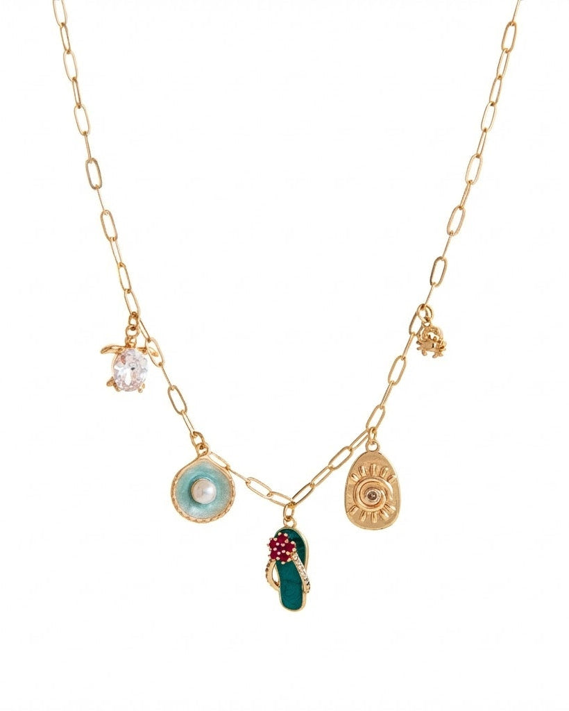 Gold necklace with various charms on a white background